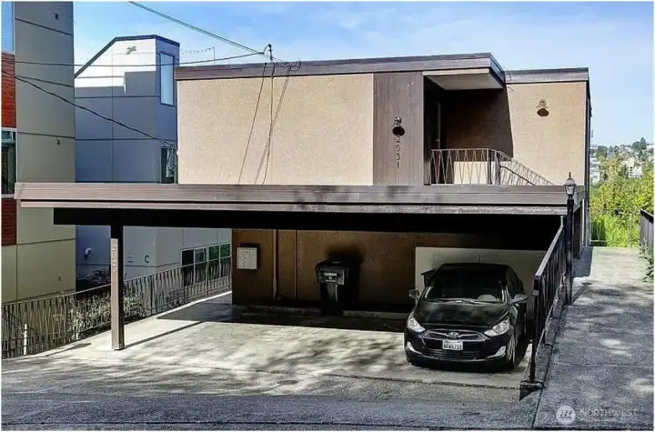 Front view with parking for three cars under carport and room for additonal cars in driveway. Street parking is plentiful as well.