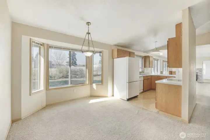 Dining area with kitchen view and ample space for a large table.