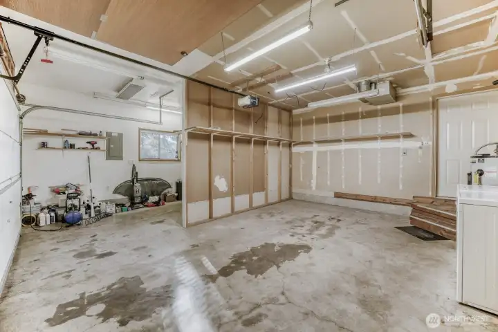 The two car garage was partially divided to create a separate workshop space.  The wall can fairly easily be removed.