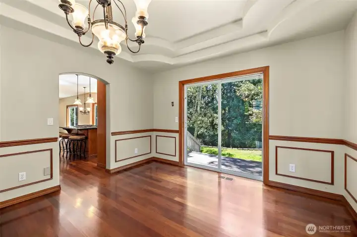 Formal dining room with slider to deck and private backyard