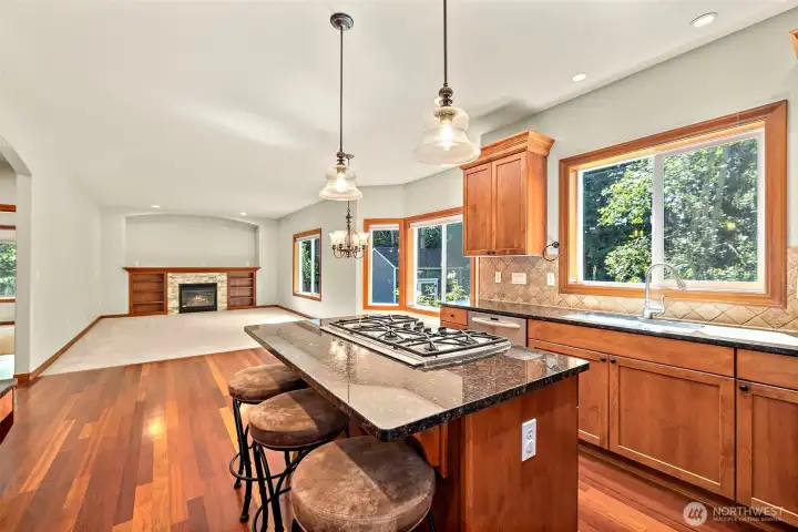 Kitchen view towards great room with fireplace