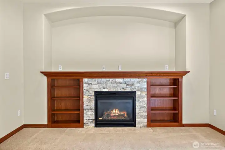Custom built in with gas fireplace and stacked stone surround.