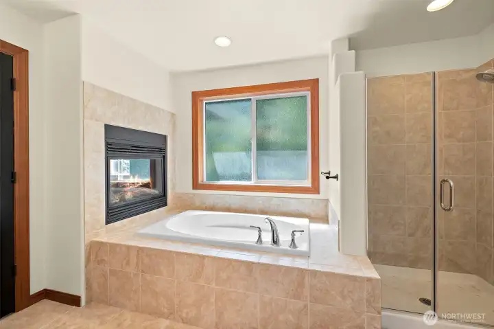 Soaking tub and dual sided fireplace