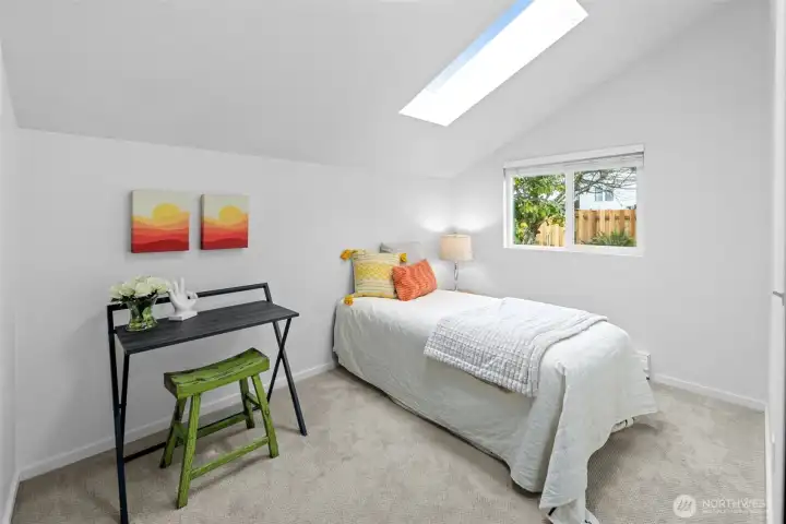 Second bedroom with backyard views.