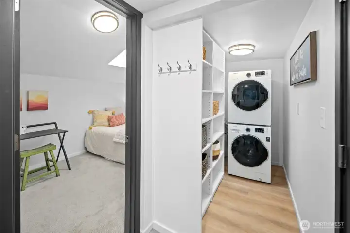 Walk-in pantry off kitchen with stackable washer and dryer.