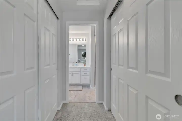primary bedroom way to bathroom, his and hers closets.