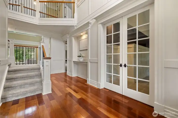 French doors to the office and past the inset is the primary bedroom.