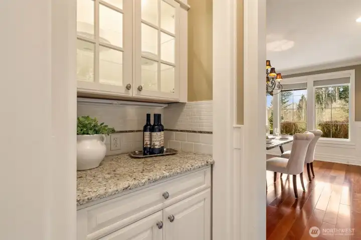 Butler's pantry between the kitchen and dining room. Great for extra storage.