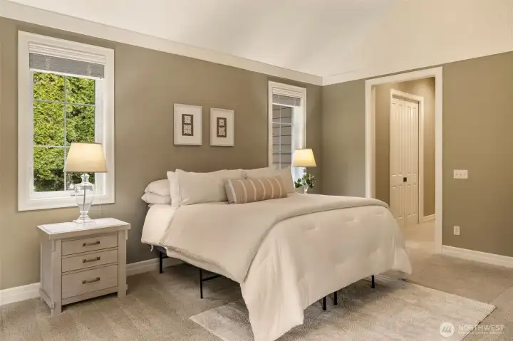 The hallway to the primary bath has a walk-in closet (shown with doors closed) and another closet across from the walk-in.