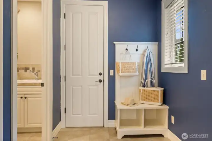 The door in the center leads to the two car garage. There's a door on the right leading to a single car garage. Laundry room to the left.