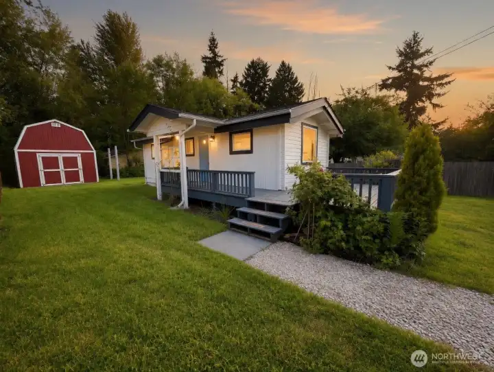 Welcome home to this picture-perfect Craftsman retreat where glowing evening light, lush greenery, and timeless architectural charm create unforgettable curb appeal. Framed by soaring trees and a spacious fully usable yard, this beautifully updated home features dramatic vaulted cedar ceilings, striking white beams, an inviting front deck, and a large red storage shed that adds both character and functionality. Warm interior lighting shines through expansive windows, creating a cozy, welcoming atmosphere that feels like home from the very first glance at a very attractive price of $385,000.