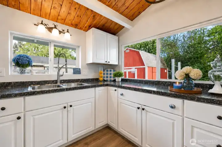 The bright and inviting kitchen blends modern updates with rustic charm, featuring beautif