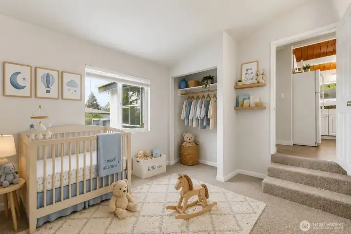 This bright secondary bedroom offers a peaceful, light-filled retreat with a new soft neutral carpeting and fresh neutral walls. A large picture window floods the room with natural light and provides pleasant views of the surrounding greenery.