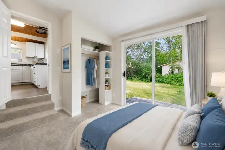 This inviting bedroom offers comfort, functionality, and direct access to the outdoors with a large sliding glass door that fills the space with natural light and opens to the peaceful backyard setting. Soft neutral tones, plush carpeting, and built-in closet storage create a warm and practical retreat, while the flexible layout provides great potential for a primary bedroom, guest room, or home office.