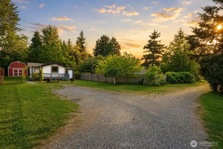 This expansive gravel driveway offers excellent first impressions and practical everyday use. It provides generous off-street parking for multiple vehicles, boats, RVs, or trailers—ideal for a property that feels private yet conveniently accessible.