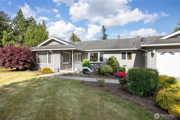 Inviting covered front entry with water feature on the side