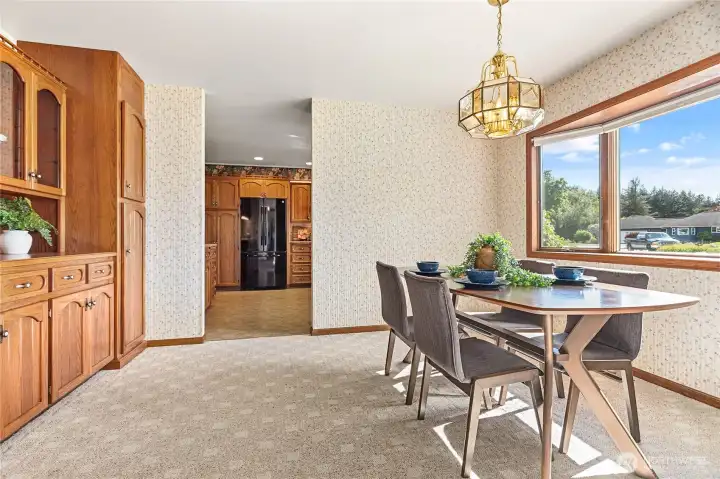 Opposite the living room & just off kitchen is great size dining room w/huge wall of built-ins. Love the warmth of the bay window and neutral wall paper (yes it's back in!)