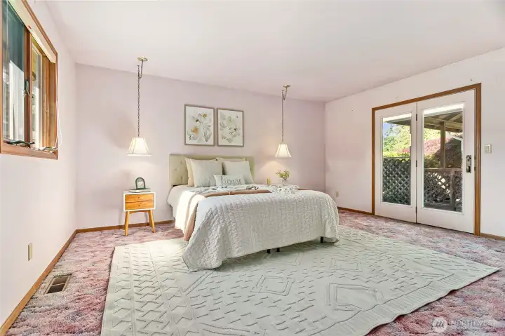Just down hall behind living room is the owner's suite. Extra spacious with your own patio door access to where gazebo-covered hot tub (not sure if it works) are located. Imagine again with just new carpet & paint - voila!