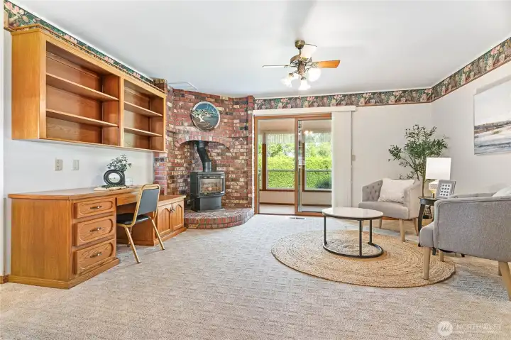 Love the original brick surround & built-in desk area! Large sunroom/solarium through slider, perfect place for your plants and to enjoy morning coffee