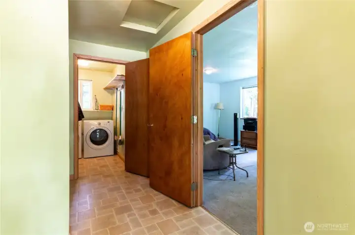 Hallway connecting bonus room, laundry, and main living area. Practical layout with room to work with.