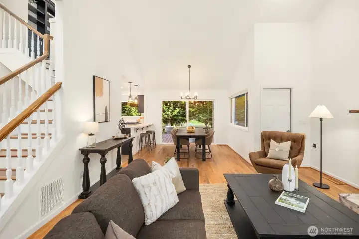 Living room opens to the dining room and kitchen with slider access to the Trex deck and lush backyard.