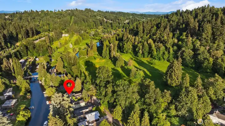 A shot looking east showing the house on the river and with a park across the street. A hidden jewel in nature mintues from all you need including great Northshore schools!