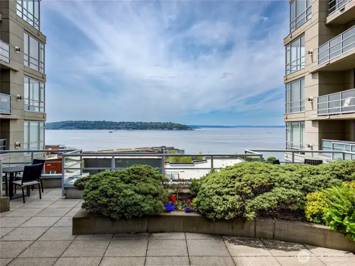 Lounge above the water with manicured greenery and endless open horizon.