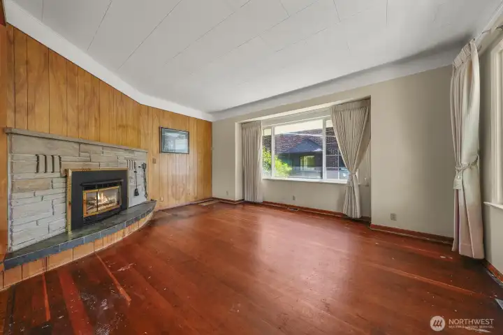 Living room with gas fireplace and original wood floors Living room with gas fireplace and original wood floors