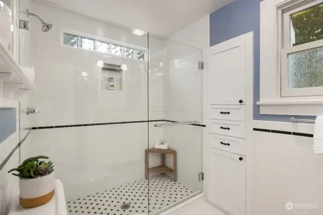 Renovated in 2017, this three-quarter bathroom on the first floor features radiant heated floors.