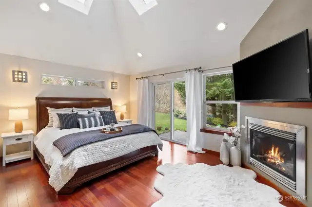 Luxurious Primary Bedroom with patio access and gas fireplace