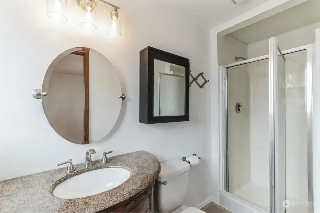 Private master bath with a walk-in shower and a stylish cabinet.