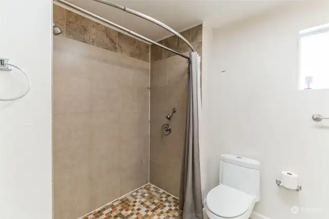 Bathroom with a large shower in the second lower-level separate living unit.