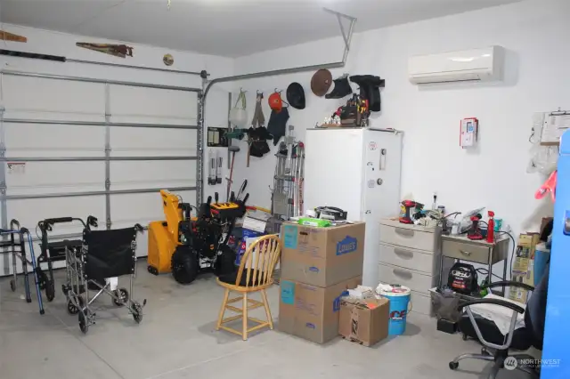Double car garage has lots of room/storage