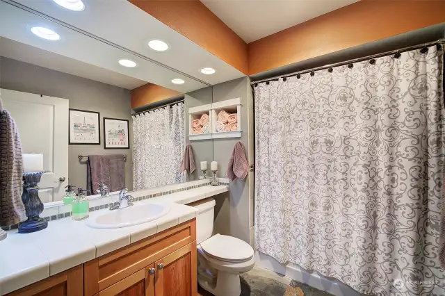 Spacious full bath complete with beautiful tile surround in shower/tub. Slate flooring and heated overhead lamp.