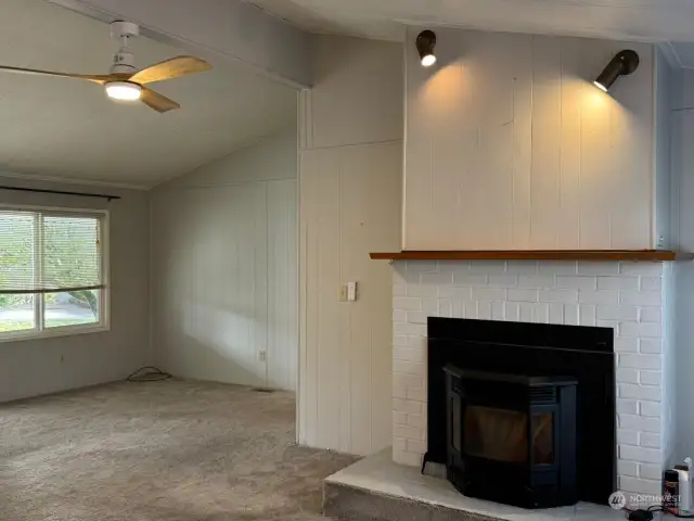 New pellet stove and additional living space with bathroom and two bedrooms behind