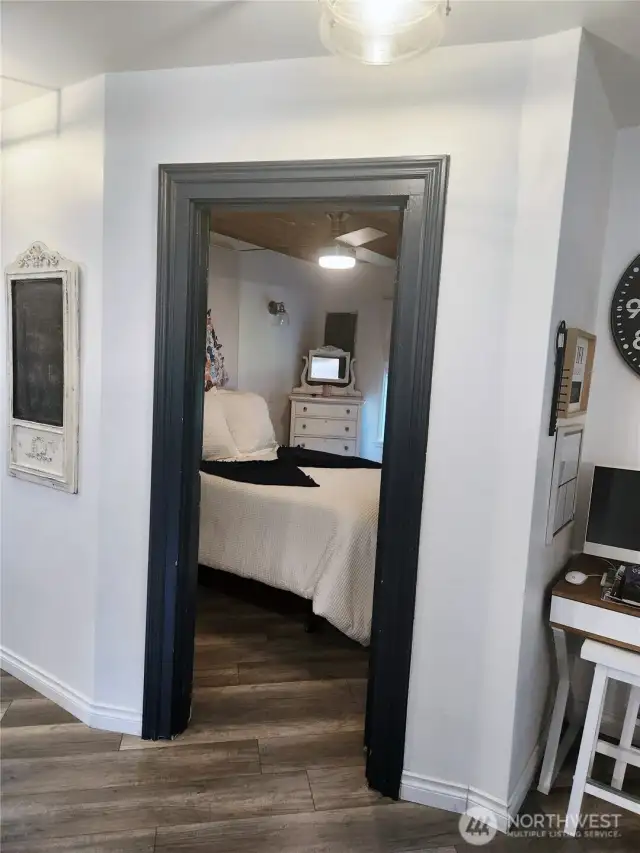 Enter to the primary bedroom right off the kitchen.