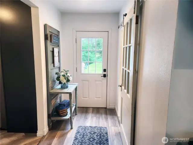 Back off the kitchen is another entry off the wrap around deck.  Barn door to the right is the bathroom.