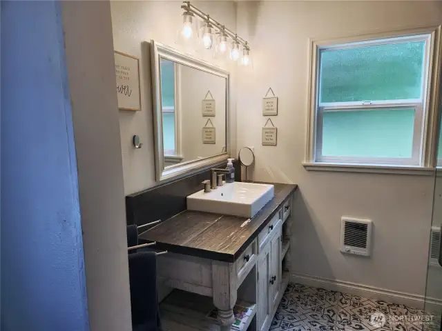 Spacious bathroom decorated with beautiful tiles and subtle colors.