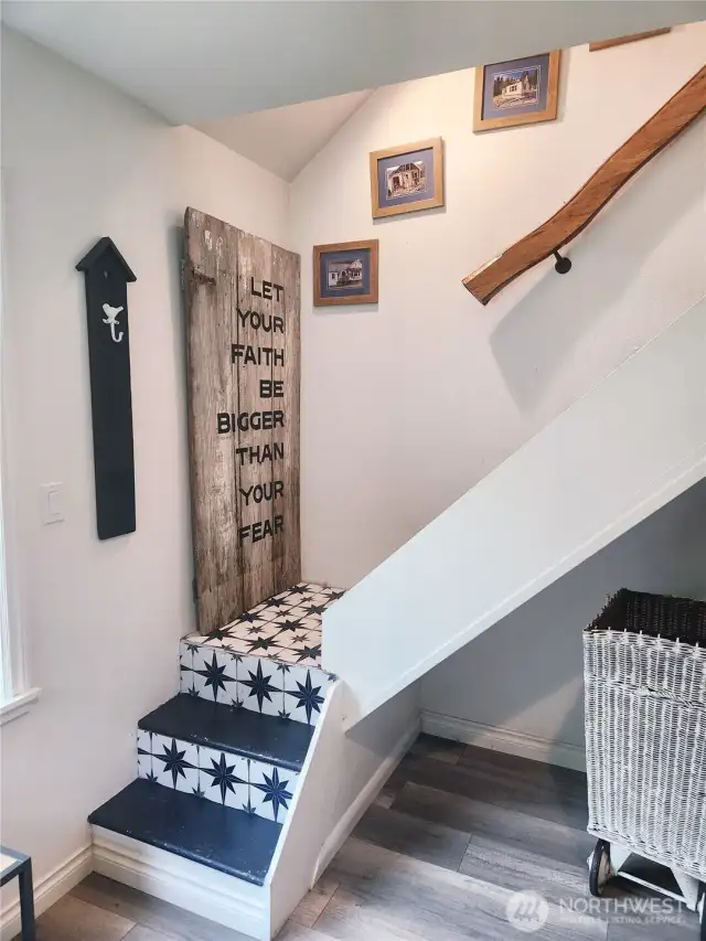 Stairs from mudroom up to second floor.  Tile coordinating with decor of the home.