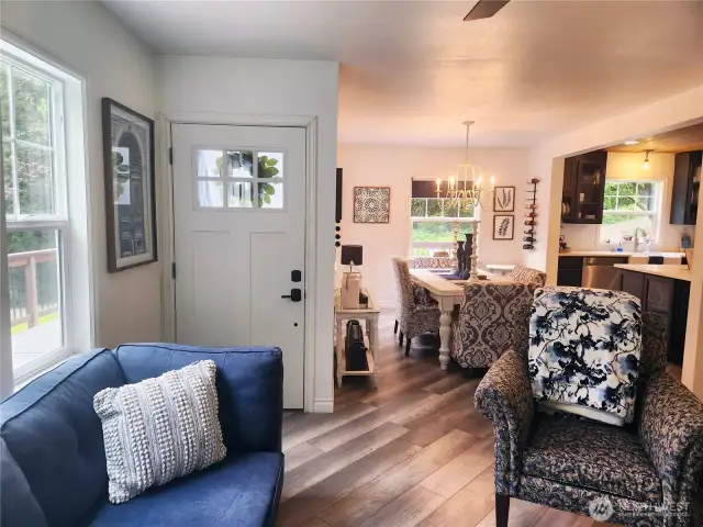 Front door leading into the living room.  Dining and kitchen in back of photo.