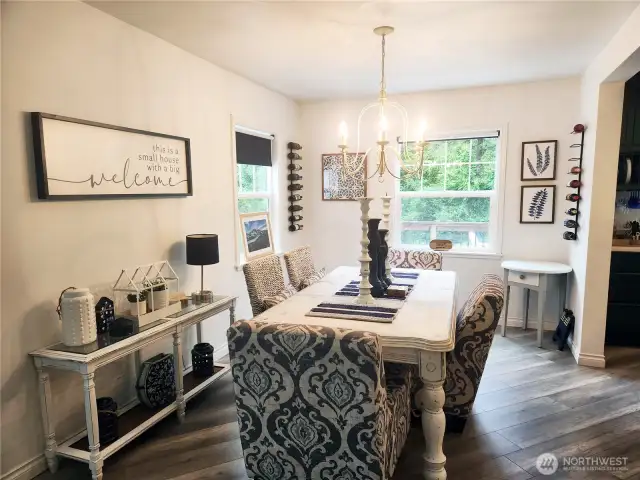 Beautiful and tasteful decor throughout the home.  The dining area is perfectly lit for enjoyable meals with family and friends. Kitchen off to the right.