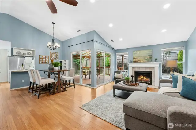 Light and bright with vaulted ceilings, canned lighting, and large windows overlooking the backyard, including TWO sliders to the covered deck.