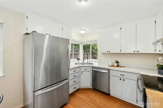 The kitchen overlooks the backyard and has stainless steel appliances.