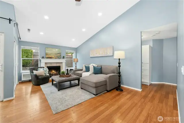 The living room features a wood-burning fireplace and has an A/C unit, just below the window that is included in the sale.