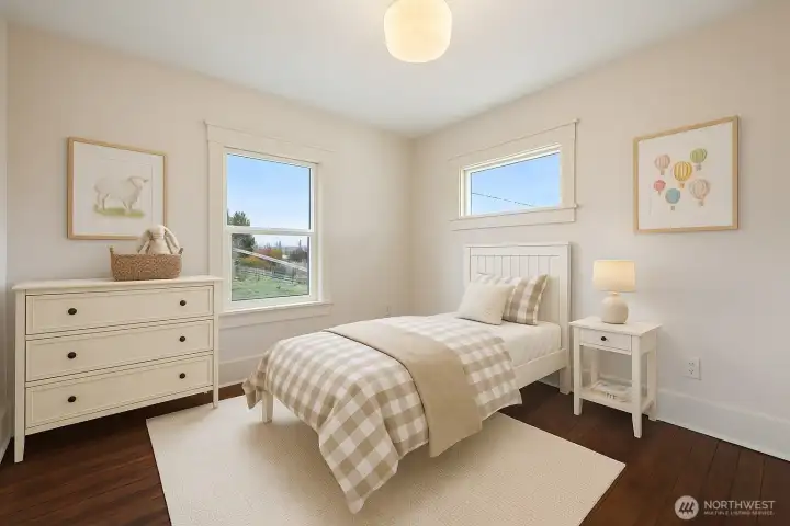 One of 3 upstairs bedrooms Front corner bedroom* virtually staged