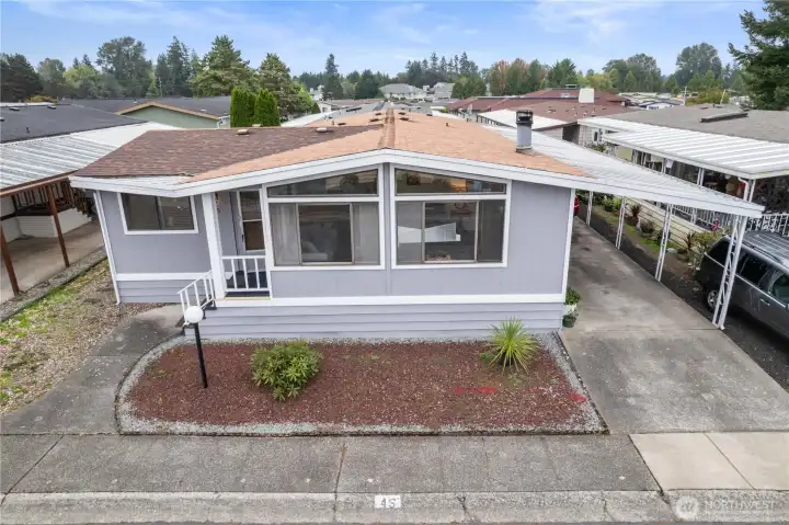 The home has a deep carport with enough space for two large vehicles to be covered