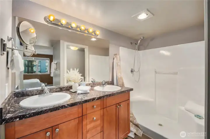 Primary Suite 3/4 ensuite bathroom with slab counters, dual sinks and private water closet