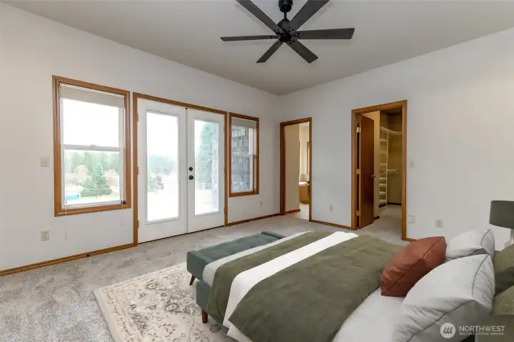 Primary bedroom with french doors to the back deck overlooking the mountain.
