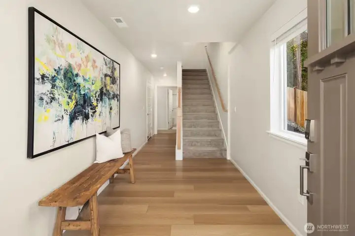 Large entryway with lower level ensuite guest room and garage access.