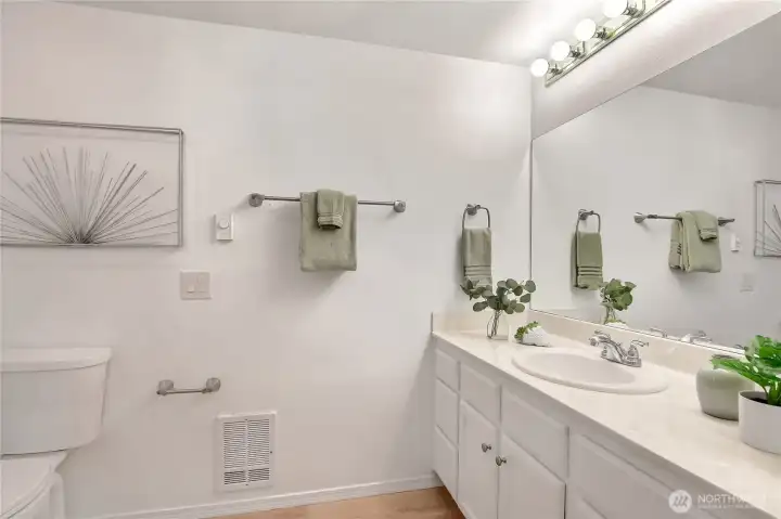 Beautiful primary bathroom with luxury vinyl plank floors